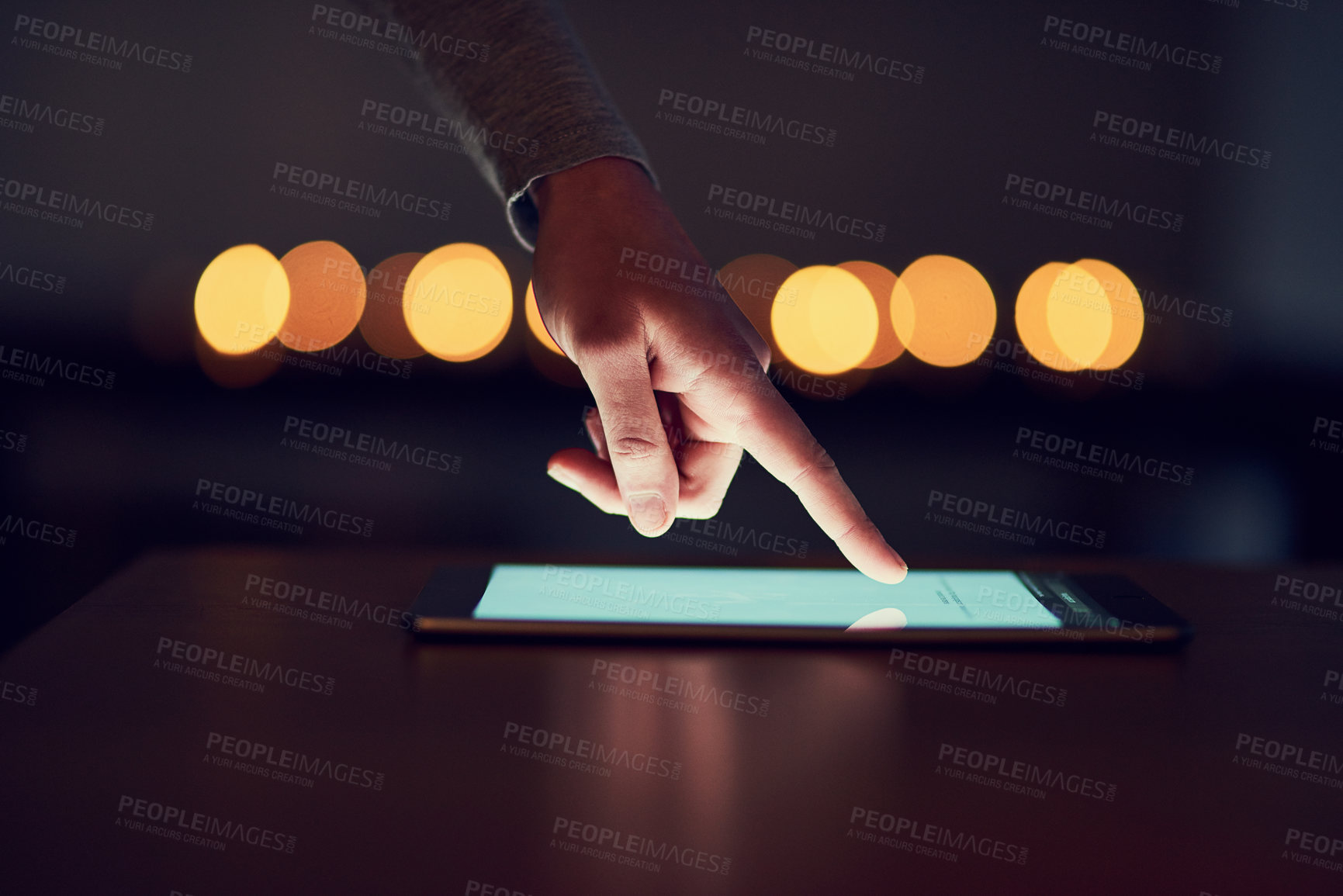 Buy stock photo Closeup of a unrecognizable person's hand browsing the internet on a digital tablet at night