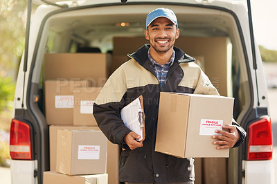 Buy stock photo Portrait of a smiling delivery man standing in front of his van holding a package