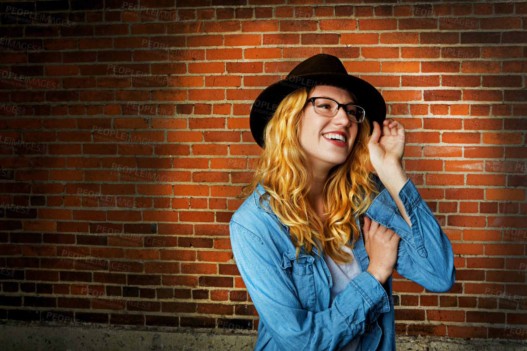 Buy stock photo Woman, happy and confident fashion by brick wall, pride and glasses or accessories for outfit. Female person, street and gen z or casual designer aesthetic, clothes and weekend travel on mockup space