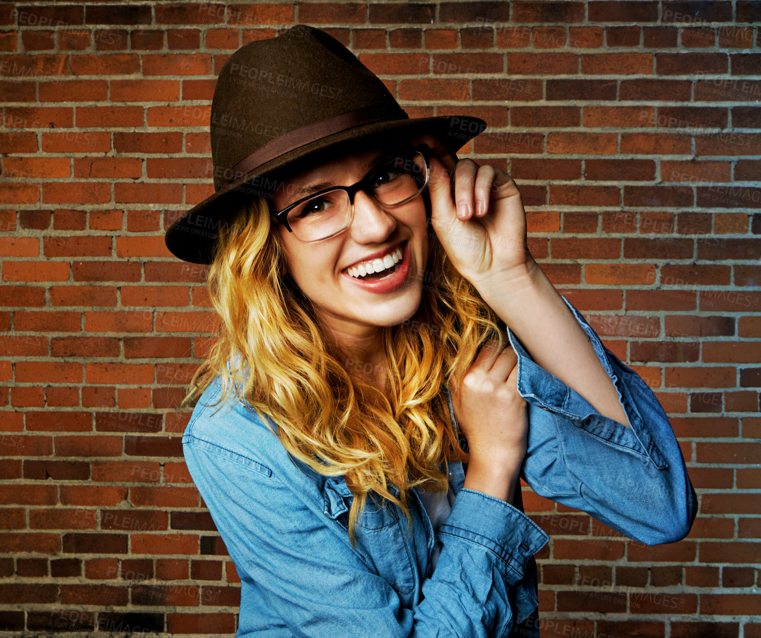 Buy stock photo Woman, portrait and confident fashion by brick wall, pride and glasses or accessories for outfit. Female person, street and gen z or casual designer aesthetic, outdoor clothes and weekend travel