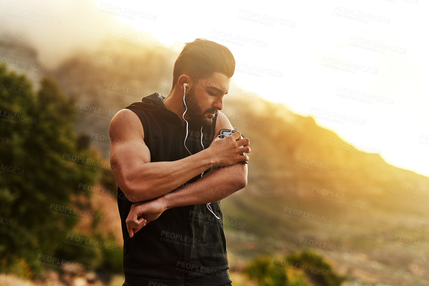 Buy stock photo Shot of a young man exercising outdoors