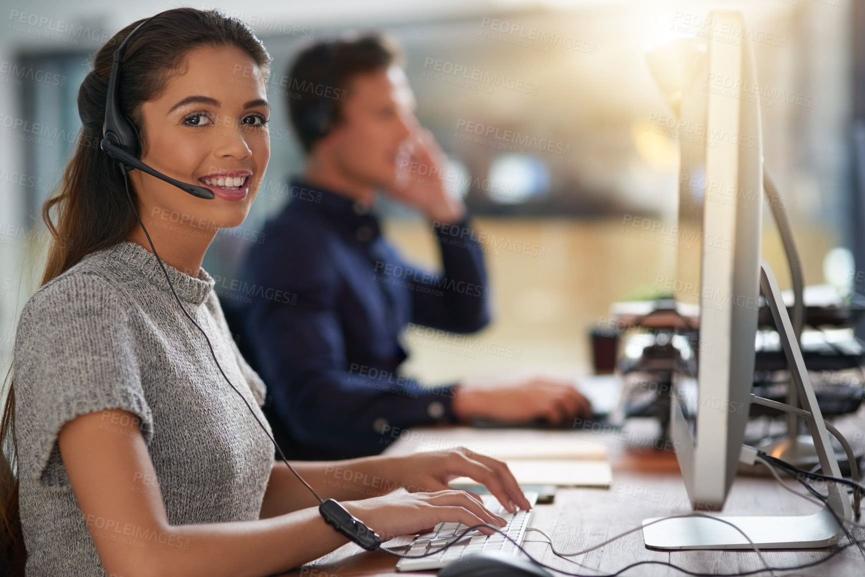 Buy stock photo Shot of young agents working in a call center