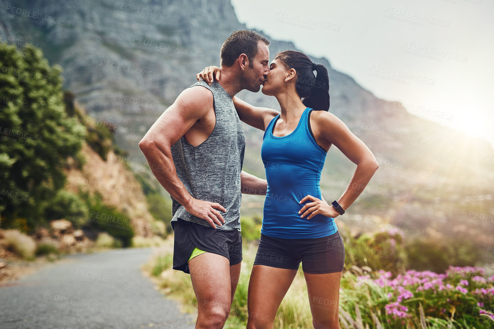 Buy stock photo Couple, kiss and fitness in nature with love, hug and exercise on mountain trail. Happy man, woman and together at sunrise for wellness, training and support in sportswear for motivation or marathon