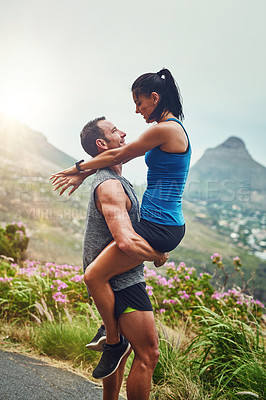 Buy stock photo Shot of a young attractive couple training for a marathon outdoors