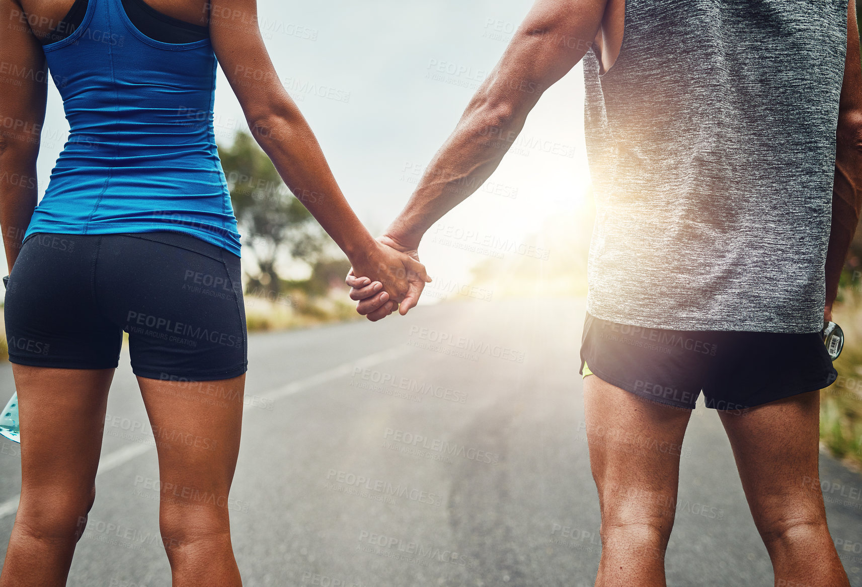 Buy stock photo Couple, holding hands and back for fitness on trail, support and exercise together in nature. Man, woman and running on road for love, athlete team and encouragement for marathon or run outdoors