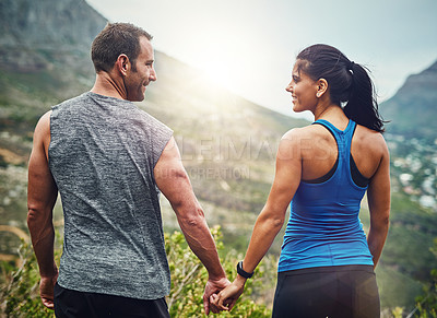 Buy stock photo Couple, holding hands and happiness for fitness on mountain, support or exercise together in nature. Man, woman and trust with view for love, motivation and encouragement for marathon or run outdoors