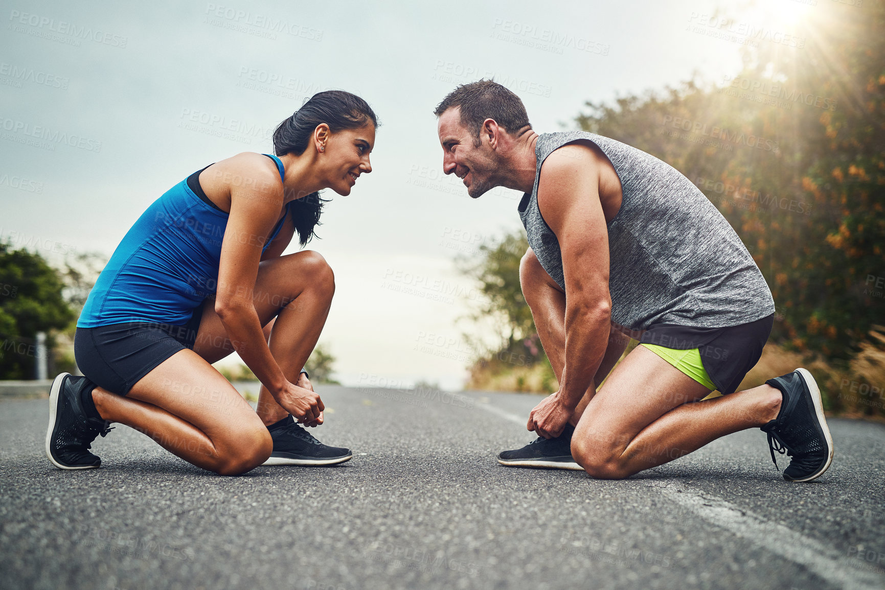 Buy stock photo Fitness, runner couple and tying shoes in road for cardio, workout, endurance training or marathon. Wellness, sneakers and athlete man with woman getting ready for running, sports or morning exercise