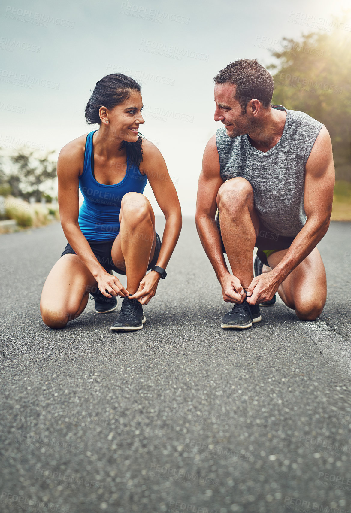 Buy stock photo Fitness, health and woman tying laces with coach on street for running training or marathon preparation. Sports, personal trainer and female athlete with warm up for cardio workout and exercise