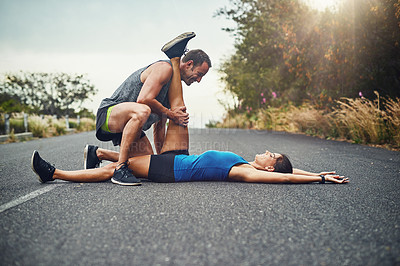 Buy stock photo Outdoor, stretching leg and couple in road with exercise for running, marathon training or cardio in morning. Flexible, warm up and athlete man with sports woman for workout, fitness or getting ready