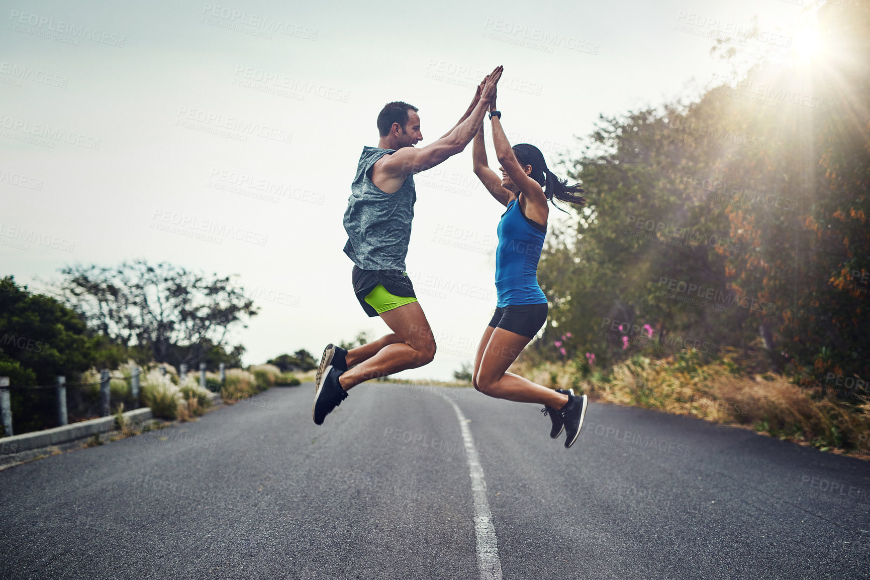 Buy stock photo Shot of a young attractive couple training for a marathon outdoors