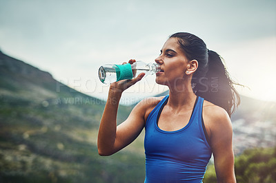 Buy stock photo Mountain, runner or woman drinking water on break to hydrate or relax for healthy energy in exercise. Tired, fatigue and thirsty girl athlete with liquid or hydration in marathon training or workout