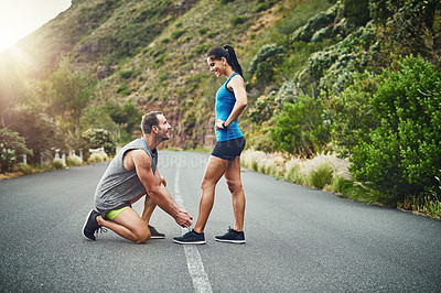 Buy stock photo Shot of a young attractive couple training for a marathon outdoors