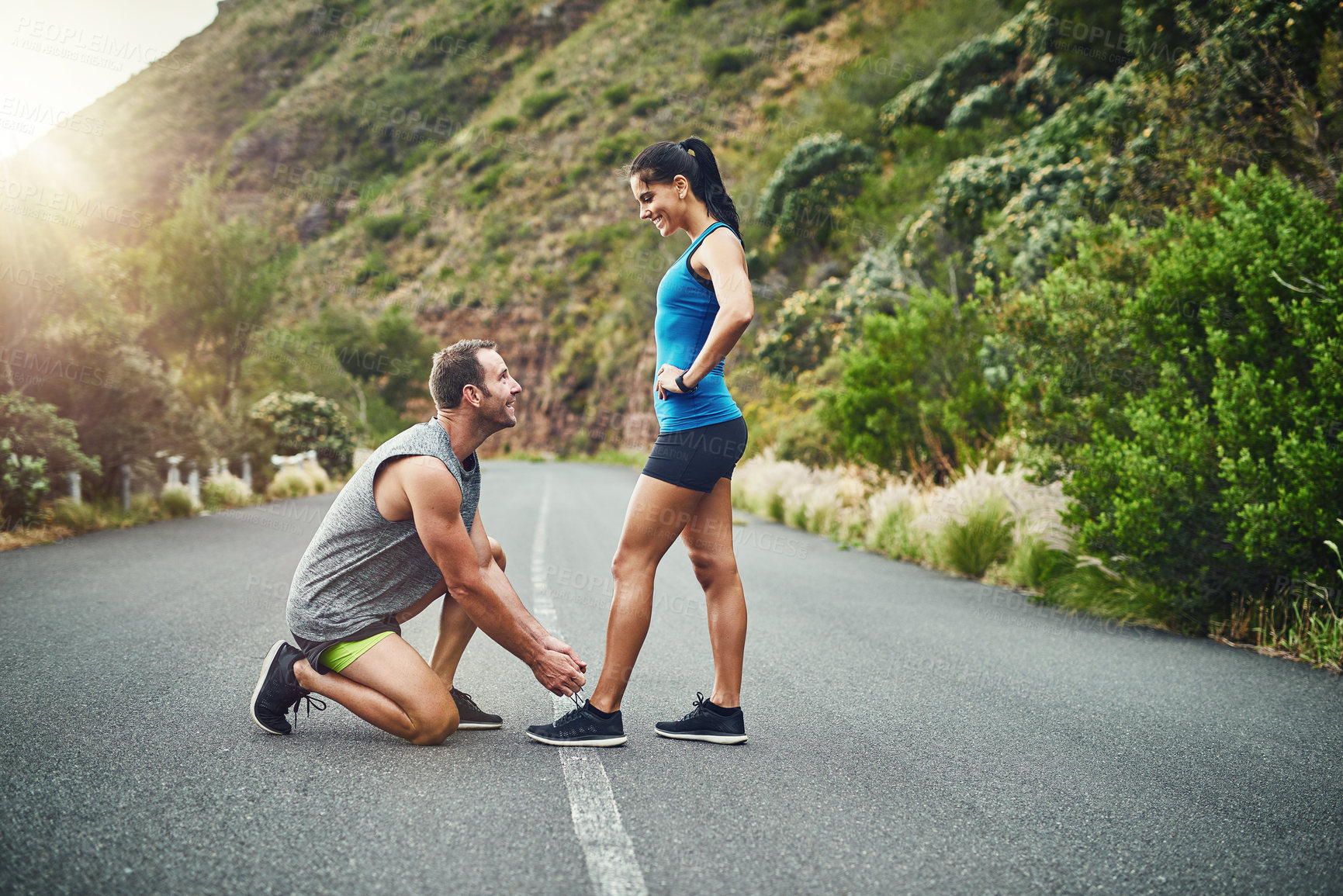 Buy stock photo Shot of a young attractive couple training for a marathon outdoors