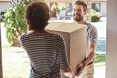 Buy stock photo Shot of a delivery man making a delivery to a customer at her home
