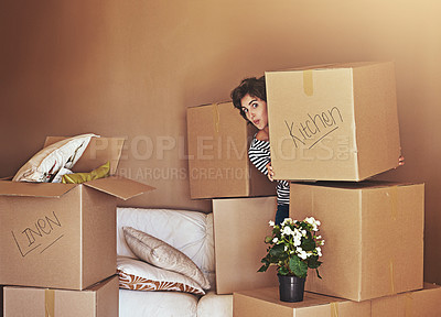 Buy stock photo Shot of a playful young woman packing up on moving day