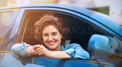 Buy stock photo Shot of a happy young woman holding the keys to a new car
