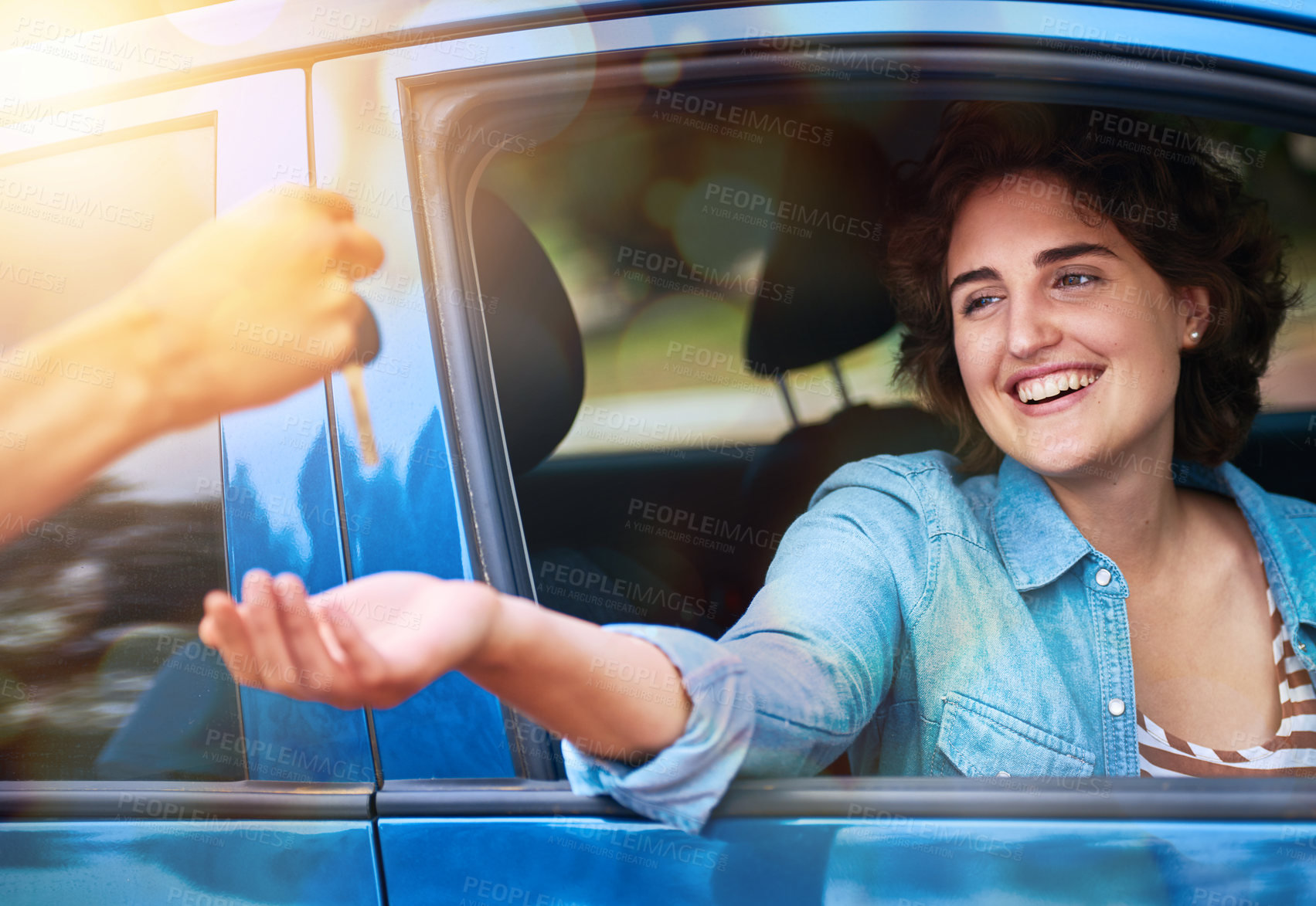 Buy stock photo Cropped shot of a man handing a young woman the keys to her new car