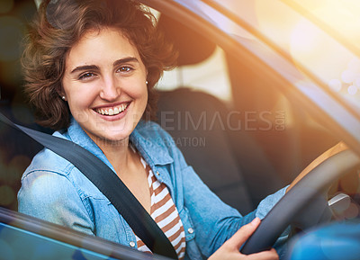 Buy stock photo Portrait of a happy young woman driving a car