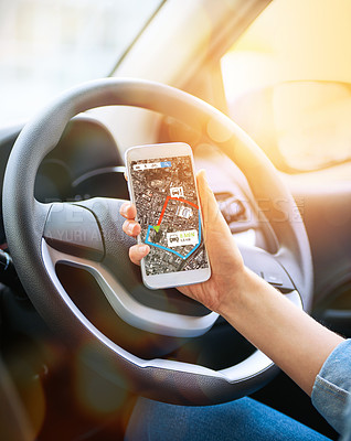 Buy stock photo Cropped shot of a woman using her phone’s gps system while driving a car