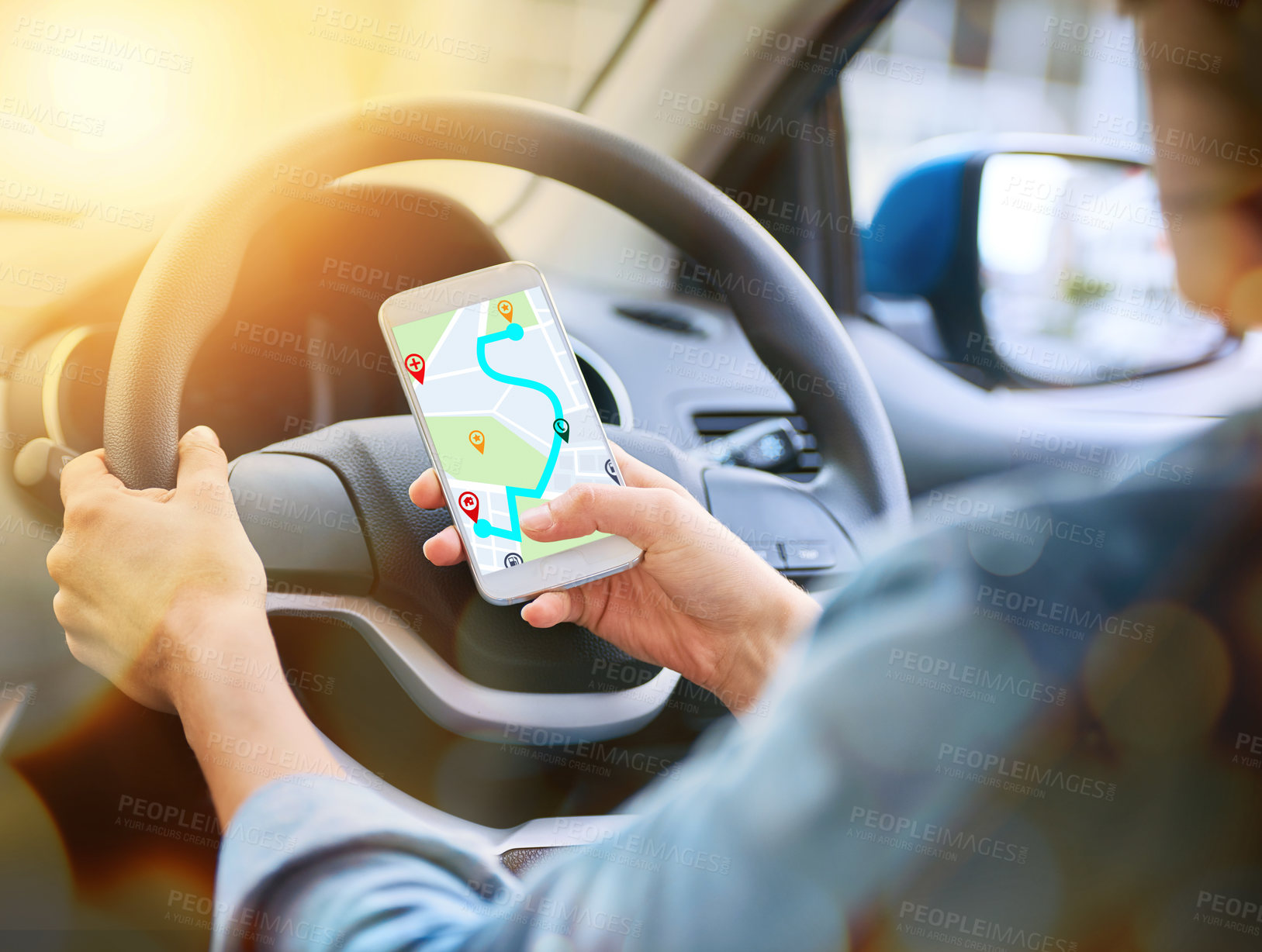 Buy stock photo Cropped shot of a woman using her phone’s gps system while driving a car