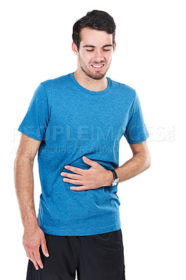 Buy stock photo Cropped shot of of a young man suffering from indigestion against a white background