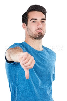 Buy stock photo Cropped portrait of an unimpressed young man giving thumbs down against a white background