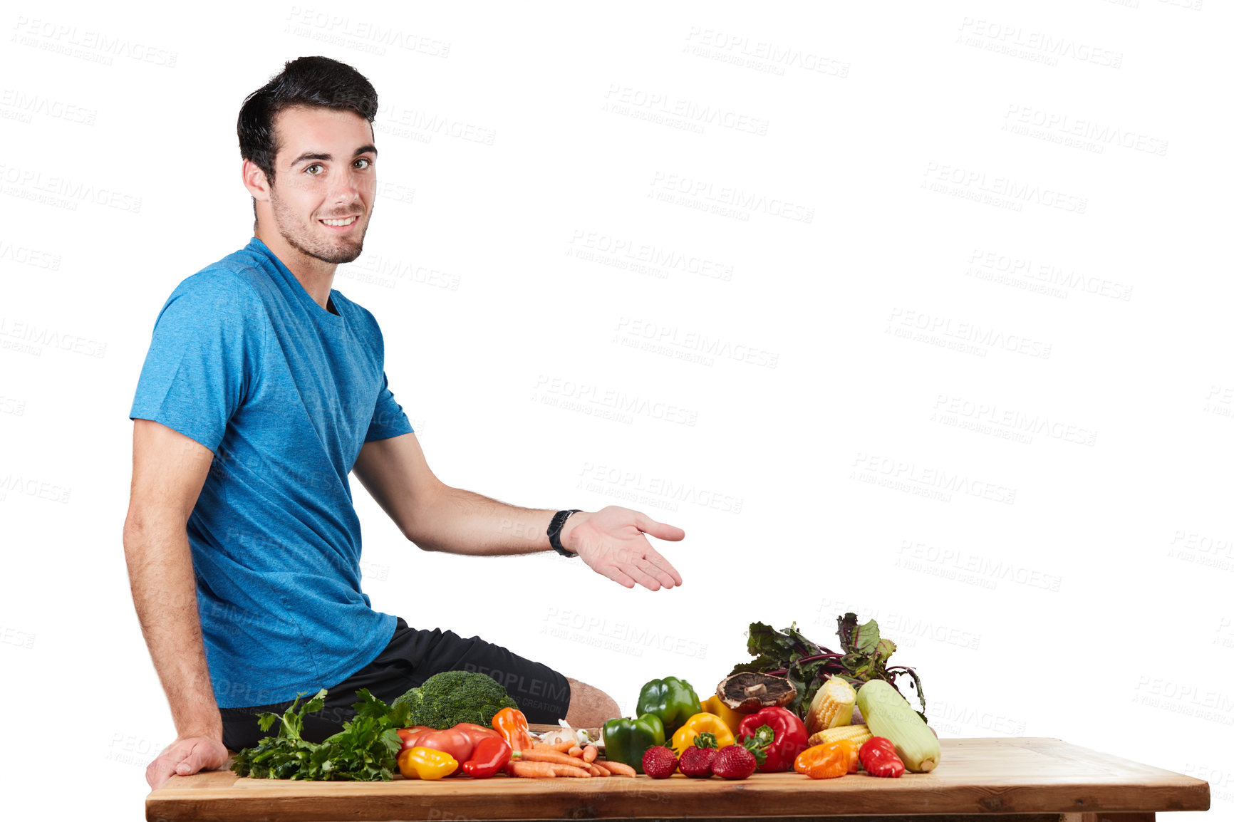 Buy stock photo Studio portrait of a handsome young man posing with a variety of fresh vegetables against a white background