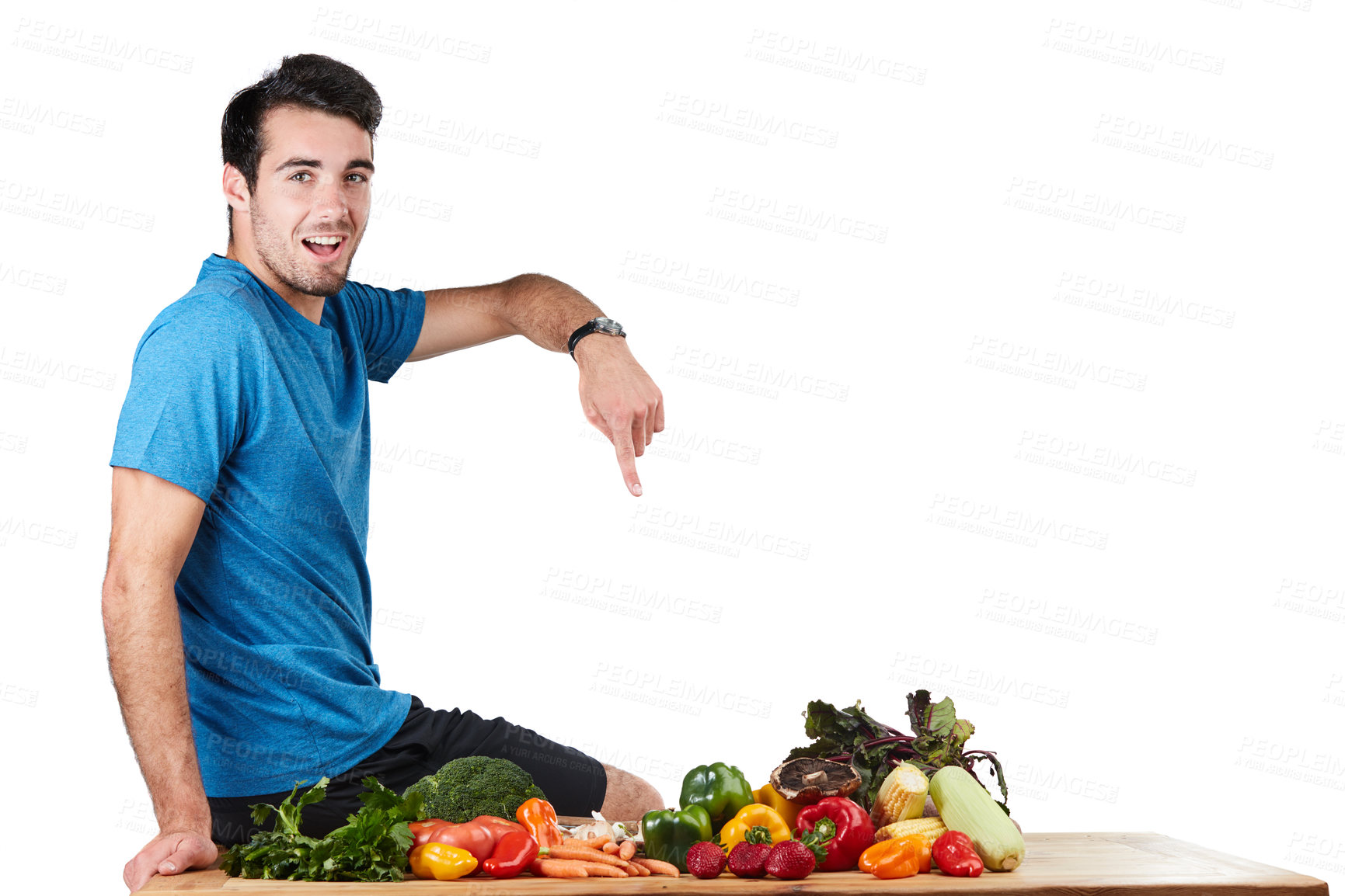 Buy stock photo Studio portrait of a handsome young man posing with a variety of fresh vegetables against a white background