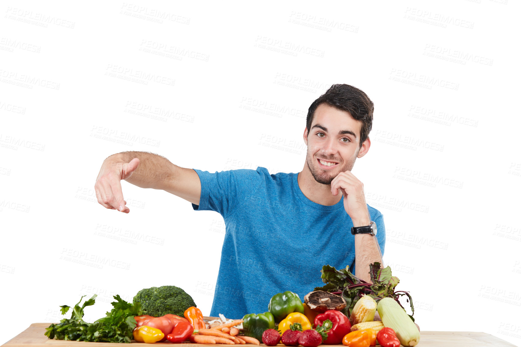 Buy stock photo Studio portrait of a handsome young man posing with a variety of fresh vegetables against a white background