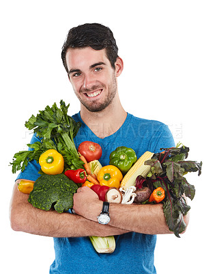 Buy stock photo Studio portrait of a handsome young man posing with a variety of fresh vegetables against a white background