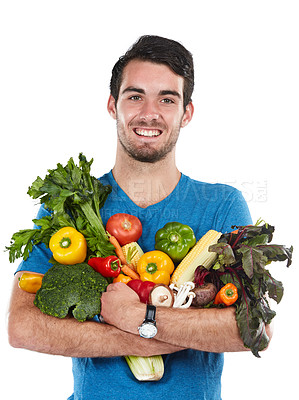 Buy stock photo Studio portrait of a handsome young man posing with a variety of fresh vegetables against a white background