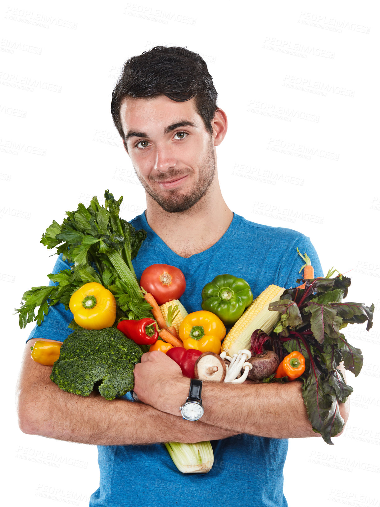 Buy stock photo Studio portrait of a handsome young man posing with a variety of fresh vegetables against a white background