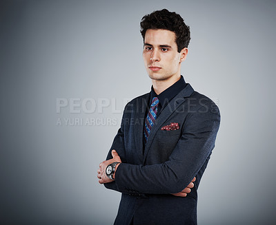 Buy stock photo Studio shot of a young businessman against a grey background