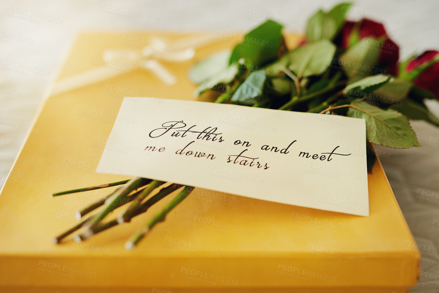 Buy stock photo Shot of a surprise gift and bouquet with a note attached to it