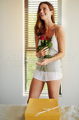 Buy stock photo Woman, bed and bouquet with roses, gift and thinking with card on valentines day, birthday or celebration. Girl, flowers and cardboard package for present with paper, excited or happy in home bedroom