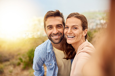 Buy stock photo Cropped shot of an affectionate couple taking selfies outside