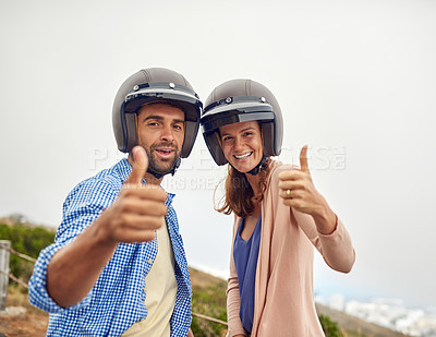 Buy stock photo Cropped shot of a couple showing thumbs up while wearing helmets outside