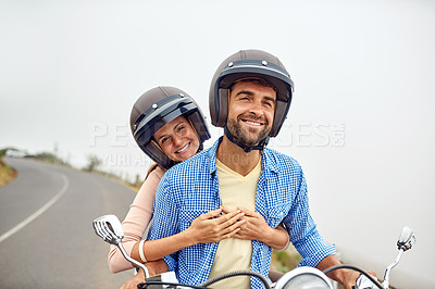 Buy stock photo Shot of an adventurous couple out for a ride on a motorbike