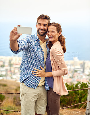 Buy stock photo Couple, hug and selfie on phone, love and outdoors on vacation, laughing and memories for social media. Happy people, smartphone and adventure or technology, travel and humor on holiday, fun and joke