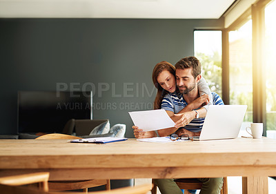 Buy stock photo Cropped shot of an affectionate young couple working on their household budget