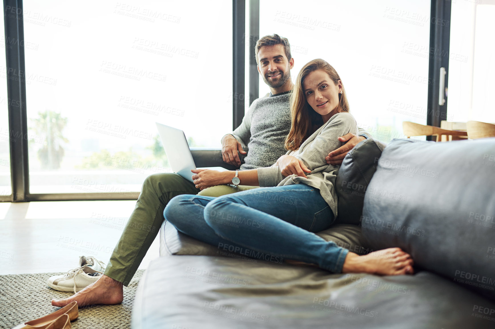 Buy stock photo Portrait, happy couple and laptop on sofa in home for relax, internet or connection for love together. Man, woman and smile by computer for social media, news and streaming on website in living room