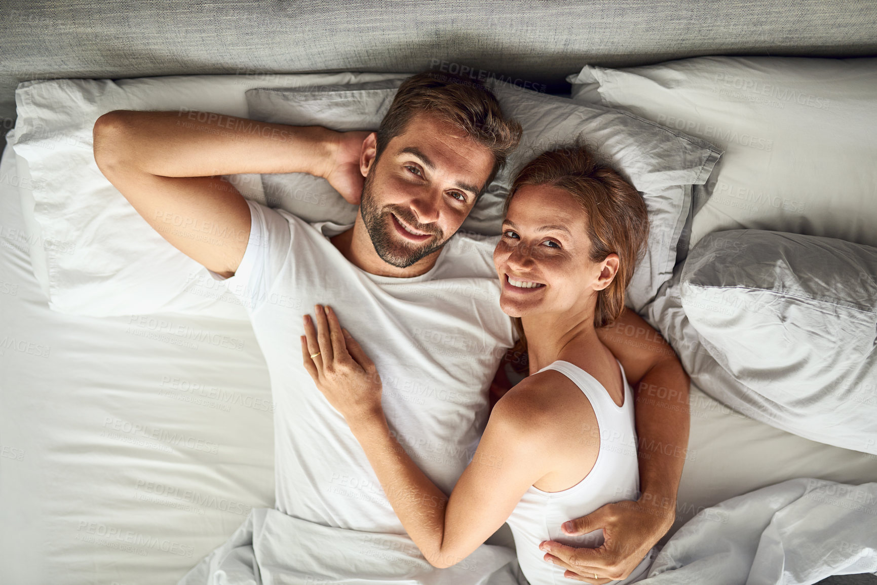 Buy stock photo Portrait, couple and relax with hug on bed in above view, peace or marriage of commitment in morning house. Smile, woman and man with embrace for care, relationship romance or bonding together 

