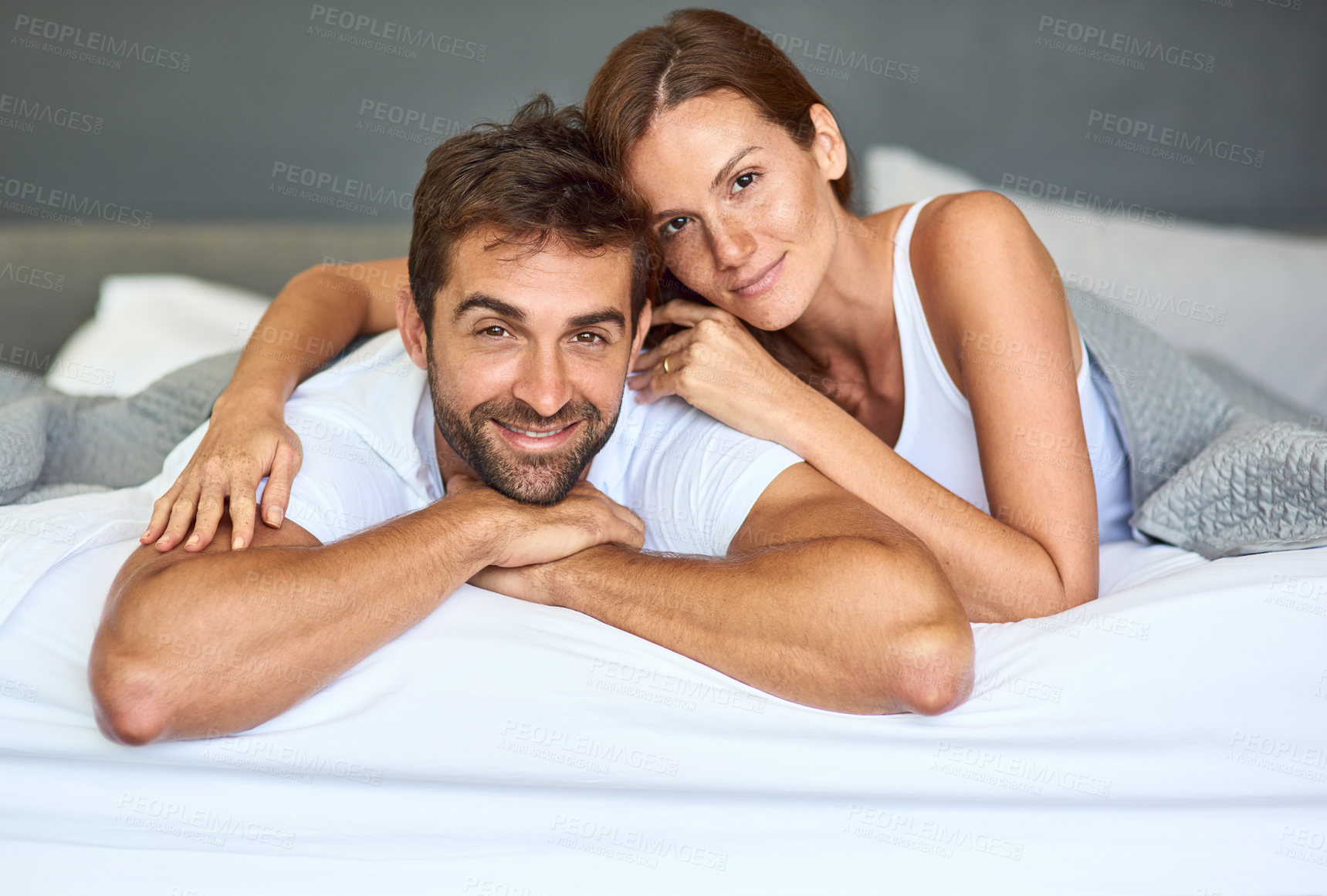 Buy stock photo Happy couple, wake up and portrait in bedroom, morning or support for marriage commitment at house. Love, bonding or people resting with smile for romantic relationship, peace or anniversary together