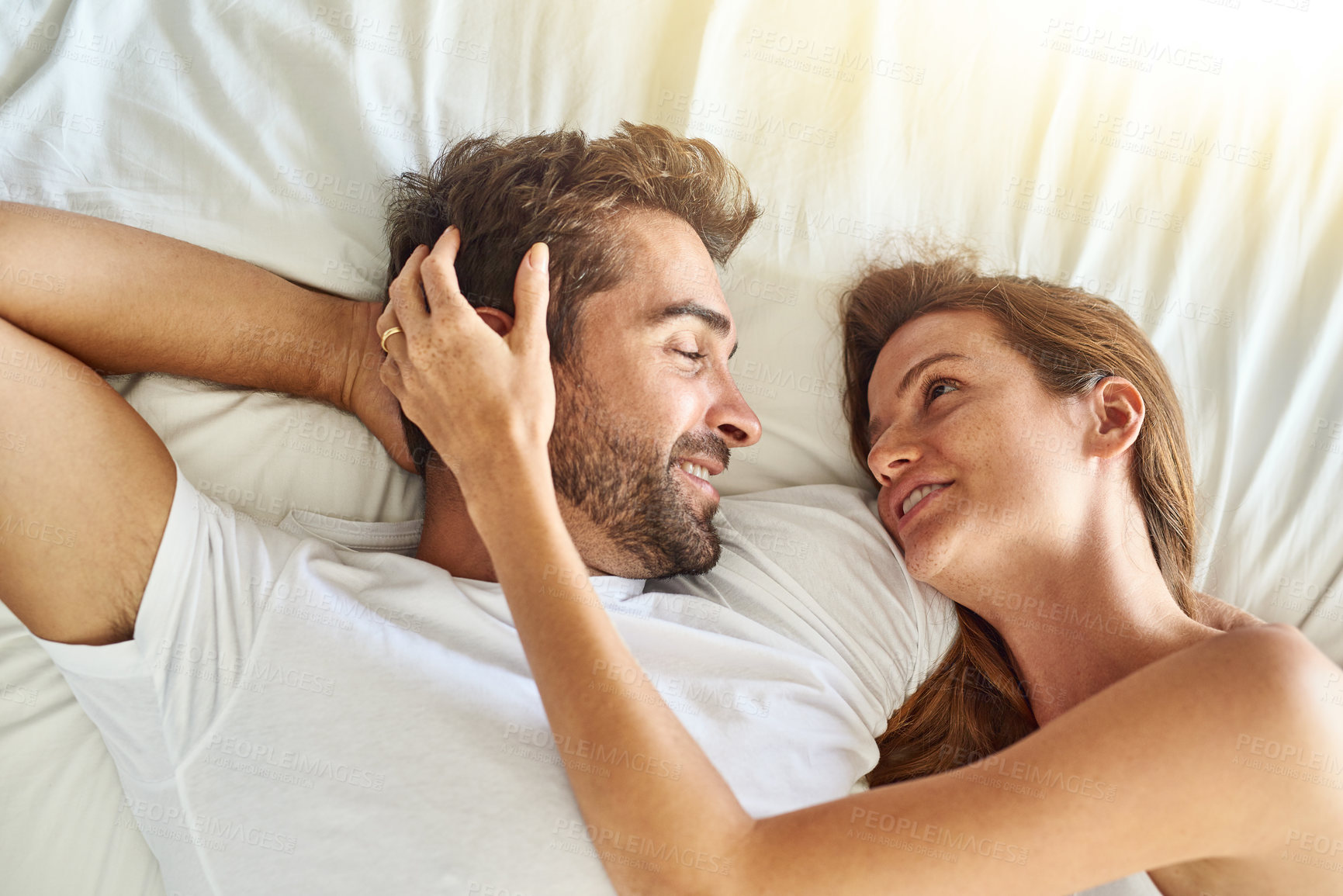 Buy stock photo Relax, couple and care with hug on bed in morning, above  or support for marriage commitment at house. Love, woman and man in embrace for relationship, romance or together on honeymoon passion