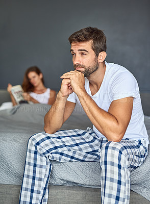 Buy stock photo Shot of a young couple having marital problems in the bedroom at home