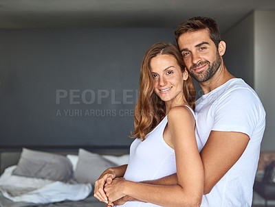 Buy stock photo Shot of a loving young couple embracing in the bedroom at home