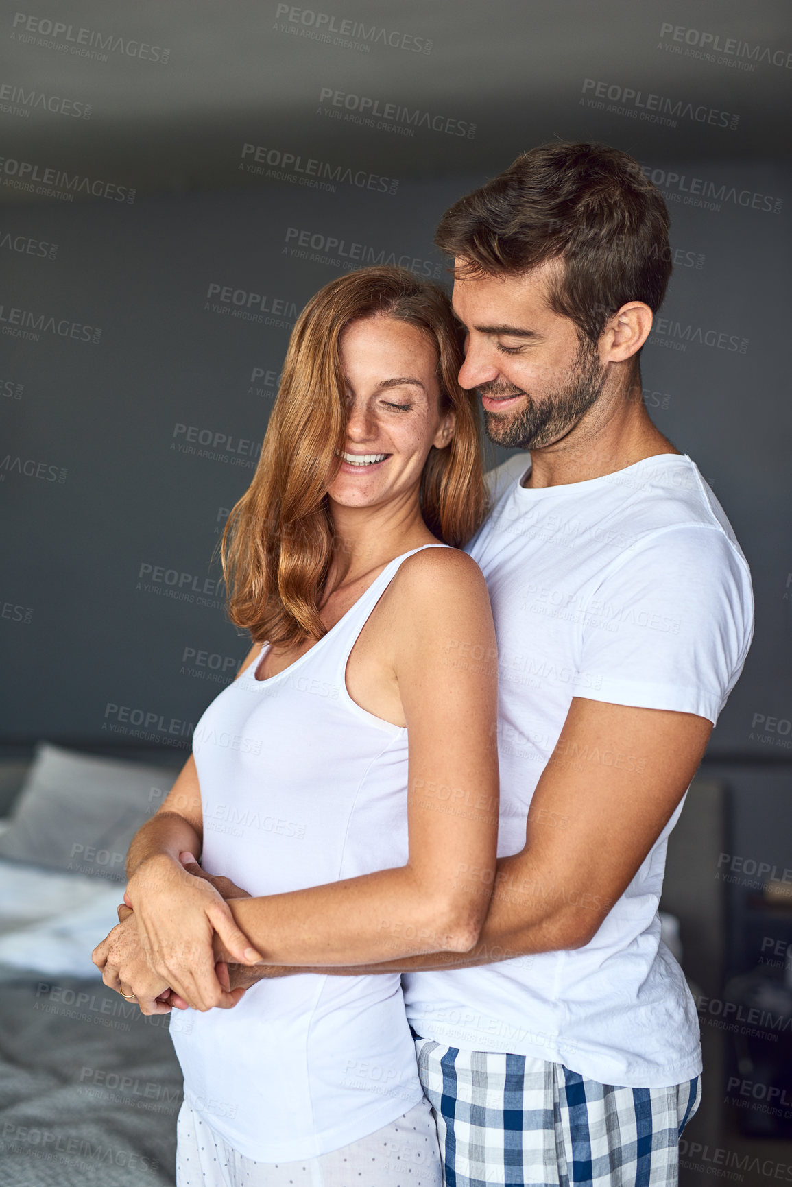 Buy stock photo Happy couple, hug and bedroom for love in relationship, romance and morning together in home. People, pyjamas and embrace for trust or support in marriage, security and relax on weekend for bonding