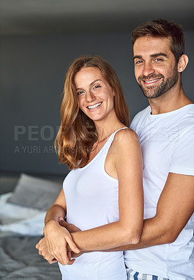 Buy stock photo Portrait, smile and couple hug in bedroom for love, care and bonding together to relax in home. Face, man and happy woman embrace for healthy relationship, support and connection at morning in house