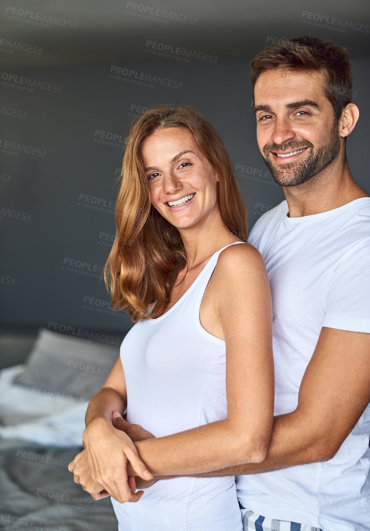 Buy stock photo Portrait, smile and couple hug in bedroom for love, care and bonding together to relax in home. Face, man and happy woman embrace for healthy relationship, support and connection at morning in house