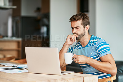 Buy stock photo Cropped shot of a handsome young male entrepreneur looking thoughtful while working from his home office